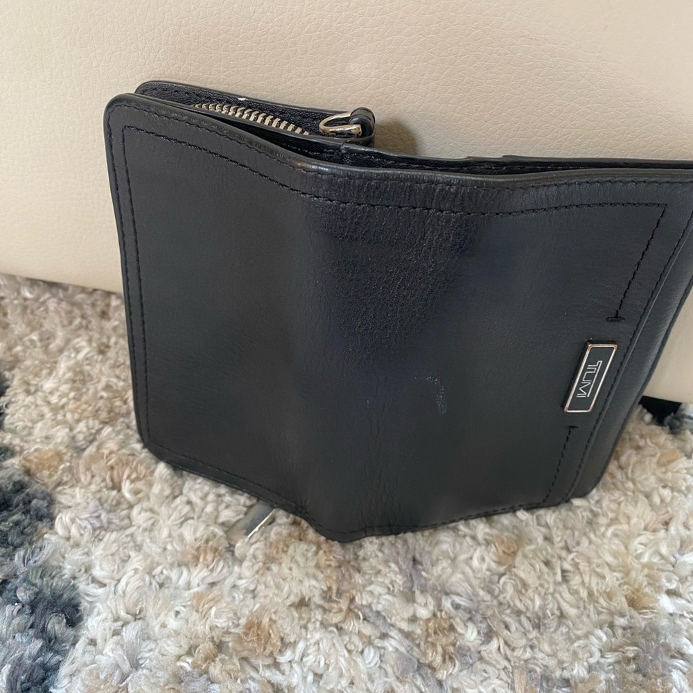 Small Black TUMI Wallet-has zipper and snap.  Many card sections, good condition